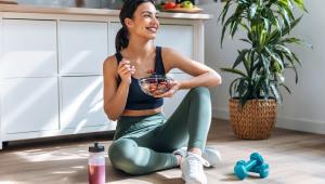 Athletic woman eating a healthy bowl of muesli