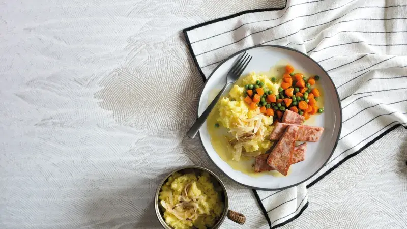 Dušená mrkev s hráškem, šťouchanými bramborami a šunkou