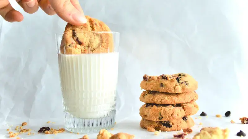 Sušenky s čokoládovými pecičkami a sklenice s mlékem