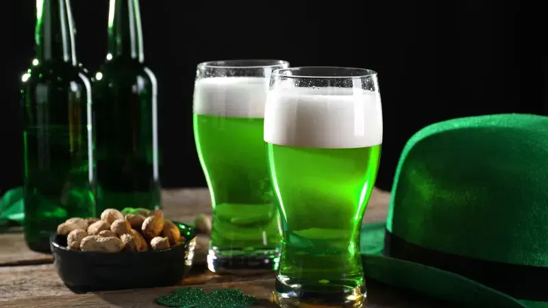 St. Patrick's day party: Green beer, nuts, leprechaun hat and decorative clover leaves 