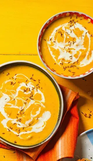 Mrkvová polévka s římským kmínem z jednoho hrnce ve dvou miskách